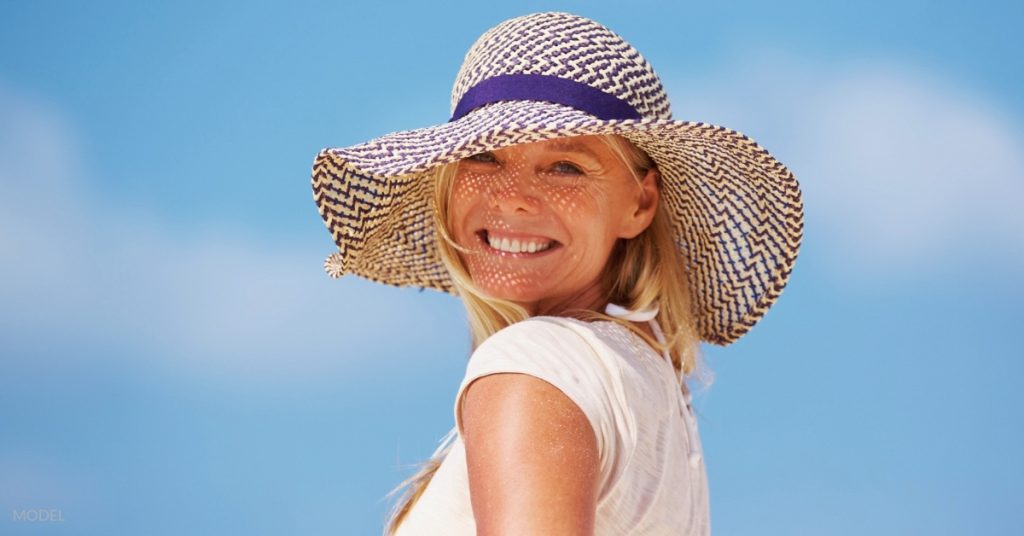 Beautiful woman wearing a beach hat (MODEL)